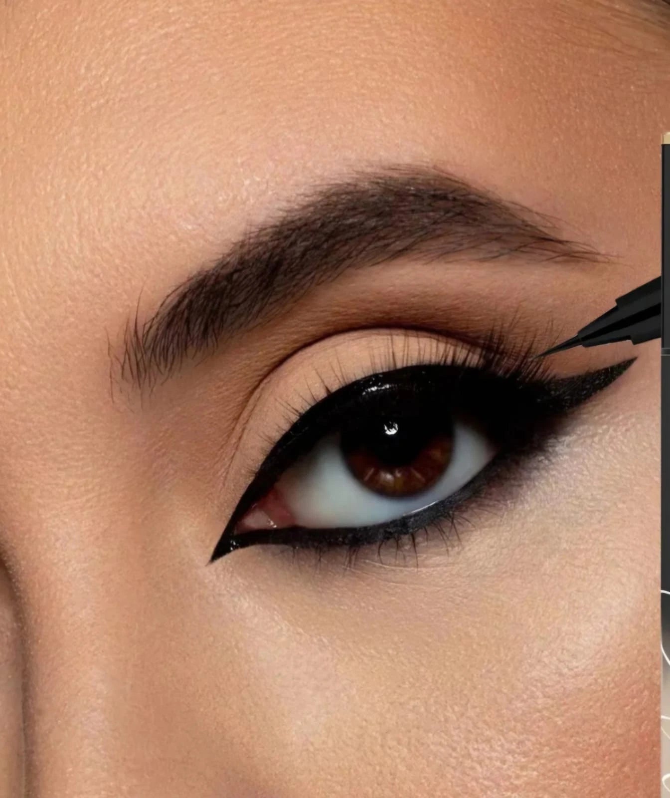 Close-up of an eye with black eyeliner being applied