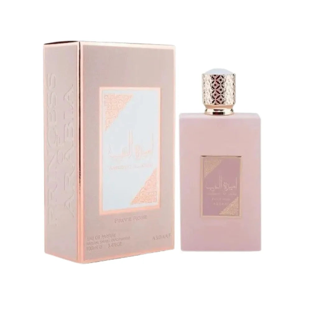 Perfume bottle and packaging with a pink and gold design on a white background