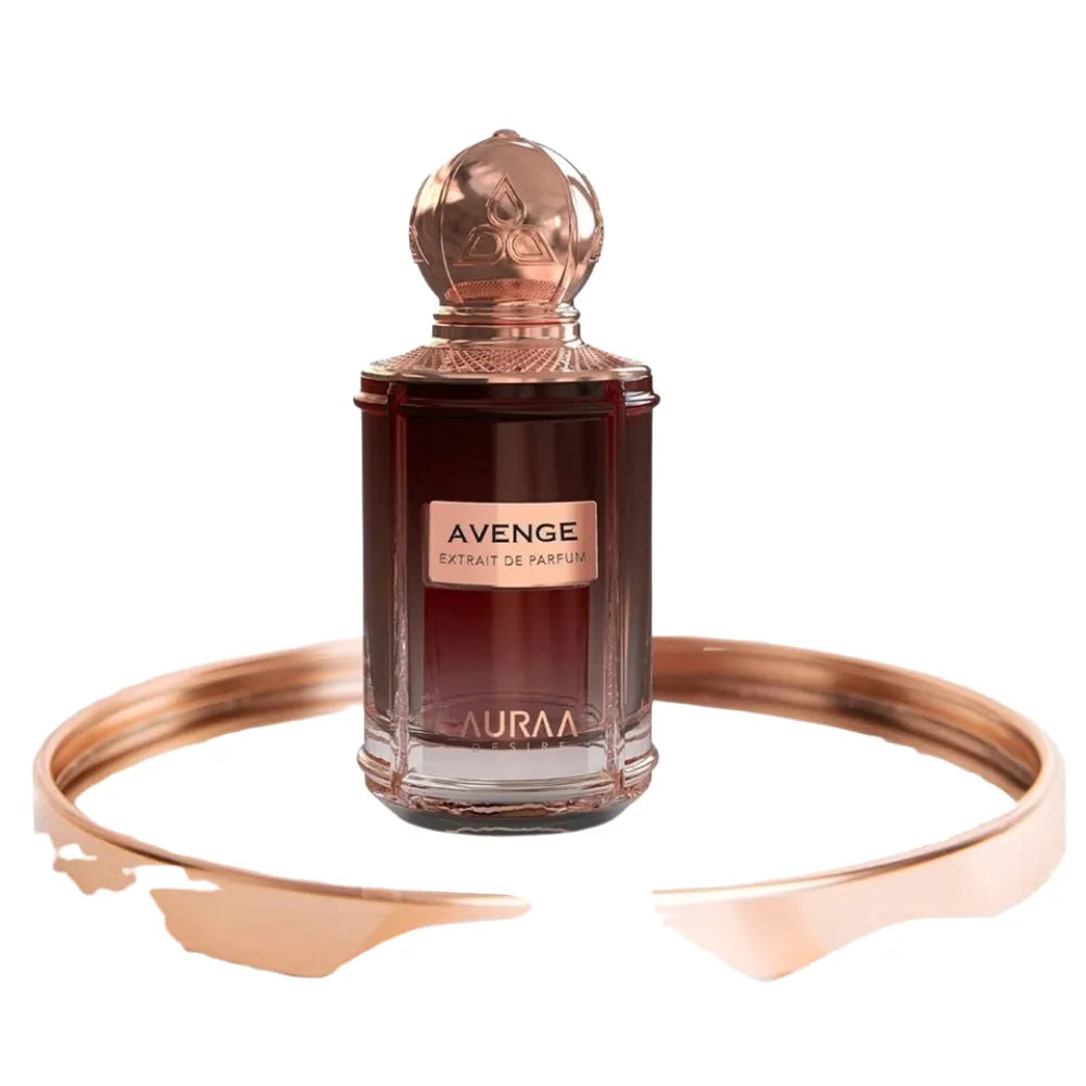 Perfume bottle labeled 'Avenge' by 'Lauraa' with a rose gold bracelet on a white background