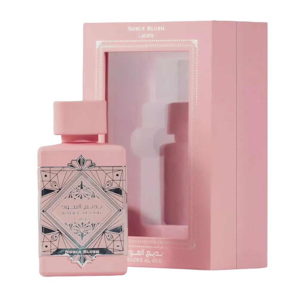 Pink perfume bottle with geometric design and matching box on a white background