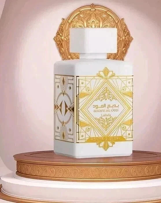 Decorative bottle with gold and white design on a wooden platform
