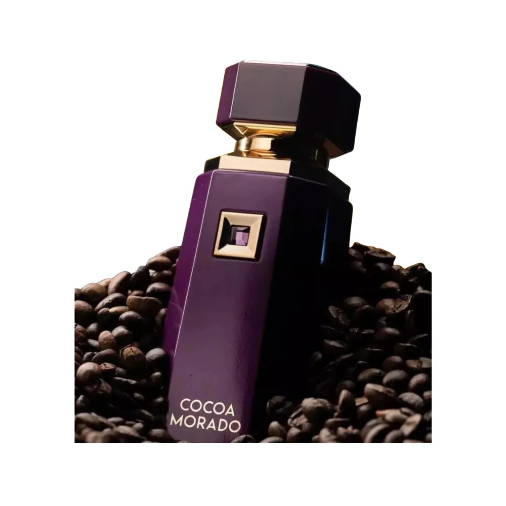 Purple perfume bottle labeled 'Cocoa Morado' on a bed of coffee beans.