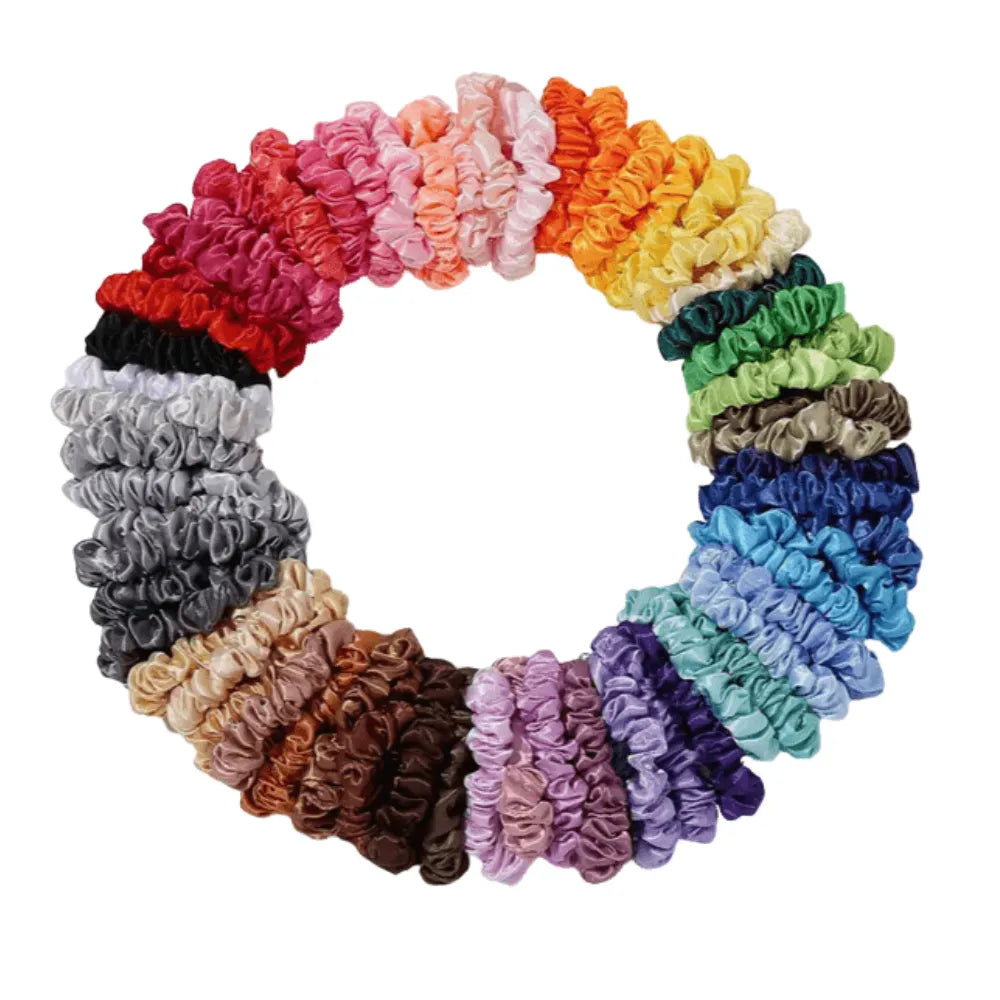 Assorted colorful scrunchies arranged in a circular pattern on a white background