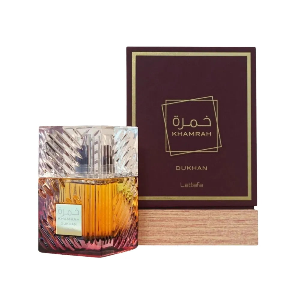 Perfume bottle with Khamrah Dukhan packaging on a white background