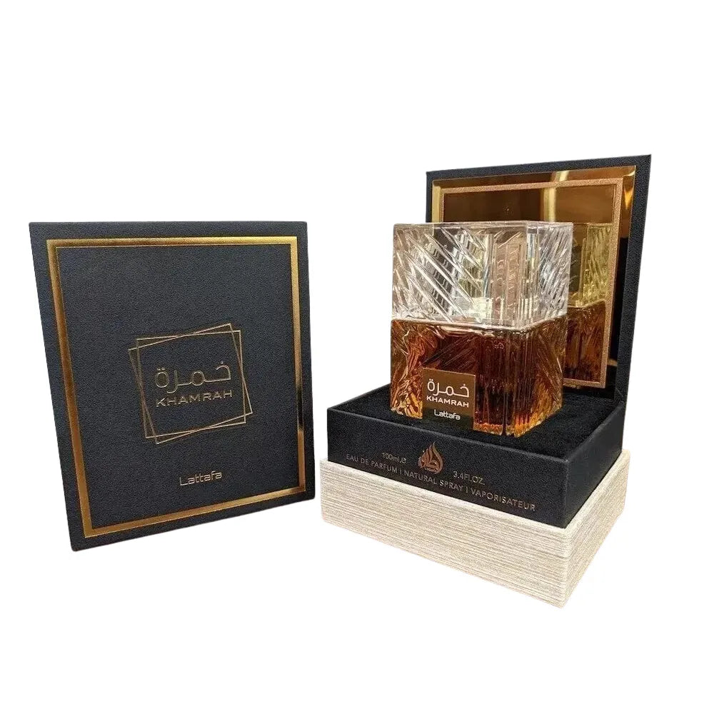 Luxury perfume bottle in an open box with a black lid featuring branding.