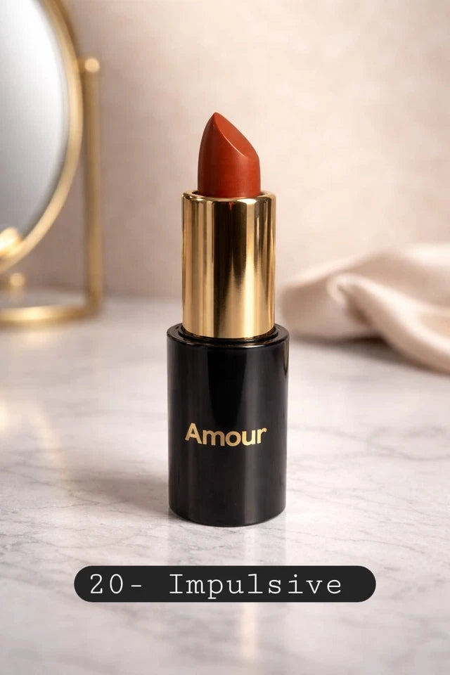 Lipstick with gold cap and black body labeled 'Amour' on a light background.