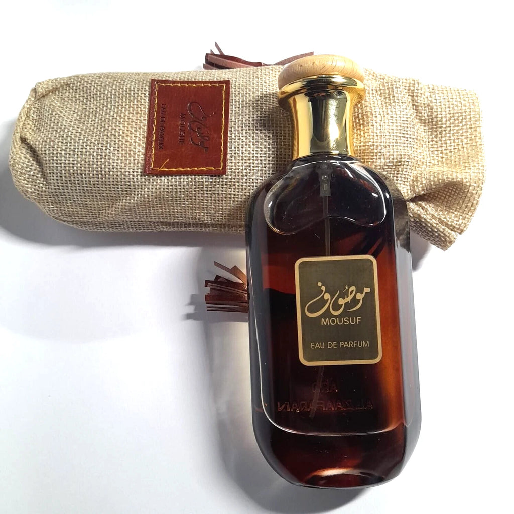 Mousuf eau de parfum bottle with a beige carrying case on a white background