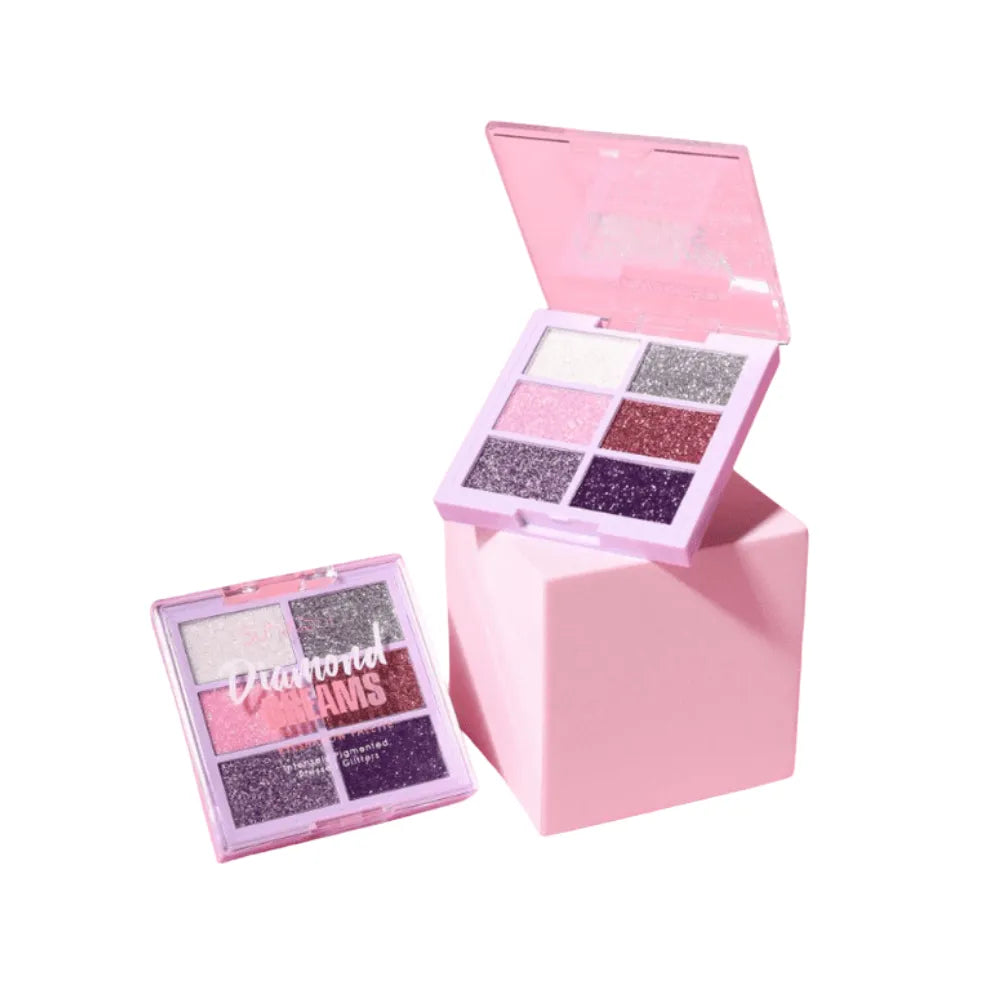 Makeup palette with glittery shades in a pink box on a white background