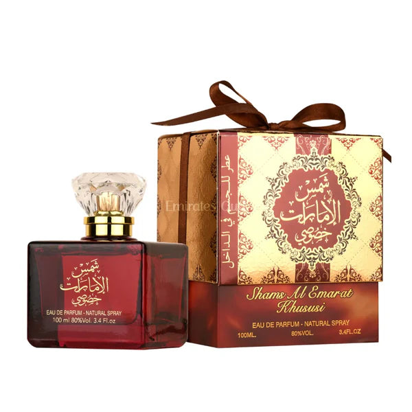 Red perfume bottle with gold cap and decorative box on a white background