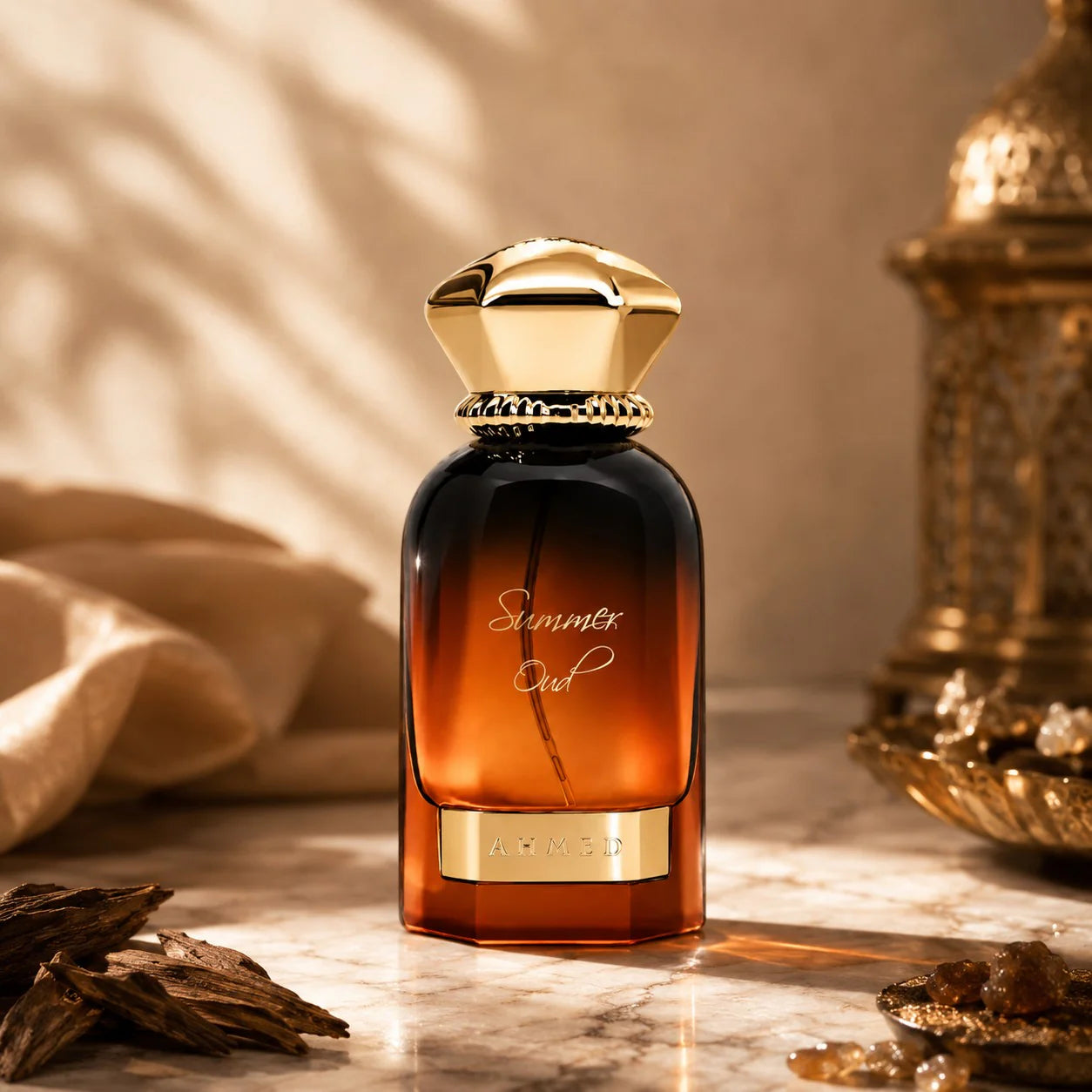 Amber-colored perfume bottle with gold cap on a marble surface, surrounded by decorative elements.