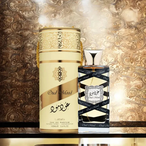 Two perfume bottles with ornate designs on a decorative background