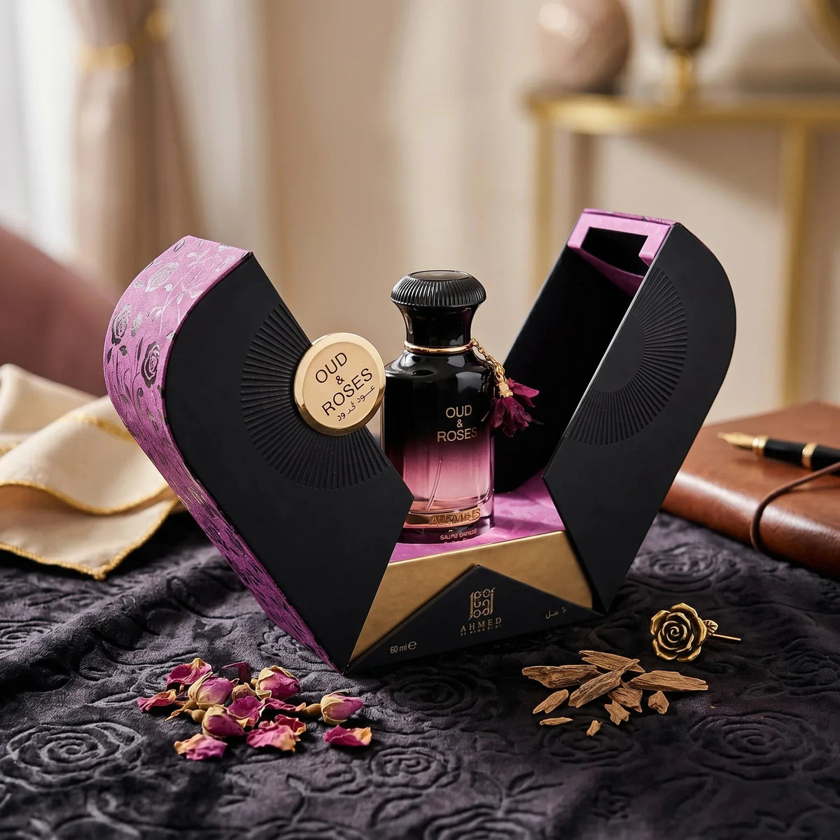 Perfume bottle with 'Oud & Rose' packaging on a textured surface with decorative elements.